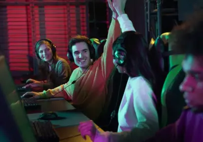 jóvenes en computadoras haciendo apuestas esports